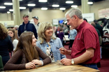 MidwayUSA Founder and CEO Larry Potterfield visiting with a future turkey hunter at the 2012 Convention