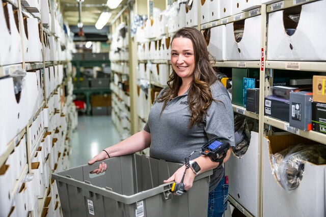 Woman in warehouse smiling