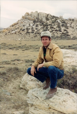 Larry Potterfield kneeling on a rock
